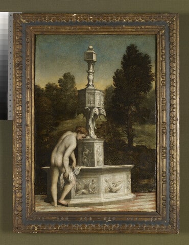 A young Man drying himself at a Fountain