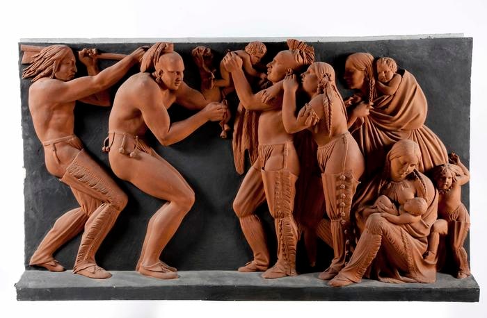 Bassorilievo raffigurante dei Nativi della Nazione Sauk-Fox e della Nazione Sioux del Mississippi, impegnati in una danza guerriera. L'opera è divisa in tre scene.